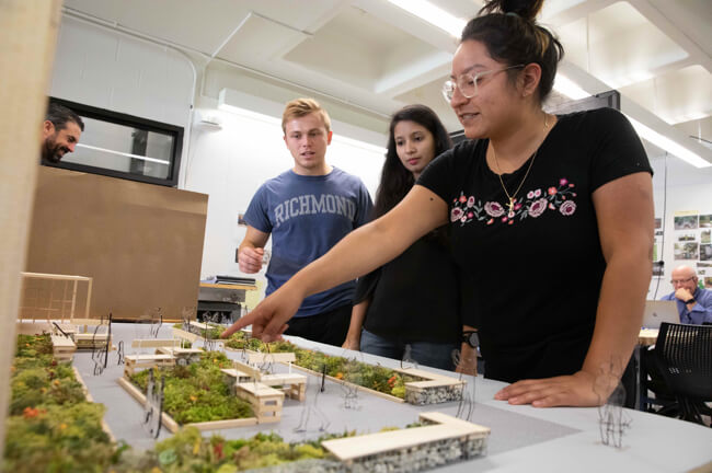 Group of people looking at a 3D model of a park.