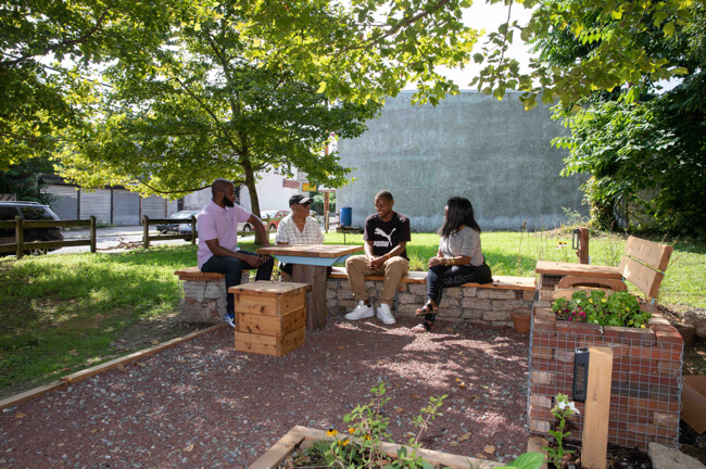 Group of people sitting in a new green space.